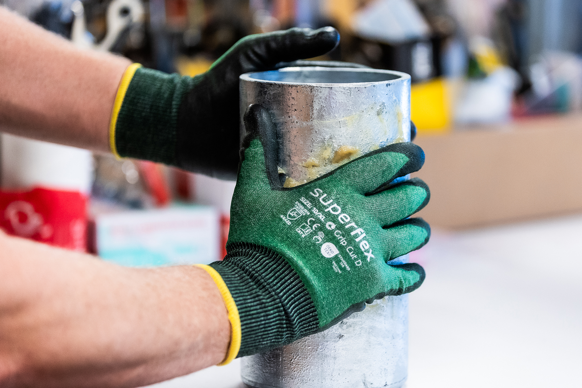 Superflex Grip Cut D work gloves gripping a metal component